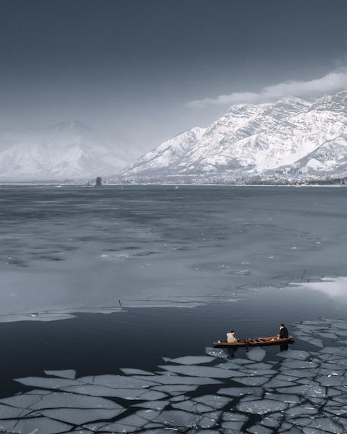 Boat on Lake Near Snow Covered Mountain
