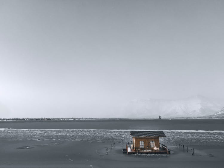 Wooden House On Frozen Lake