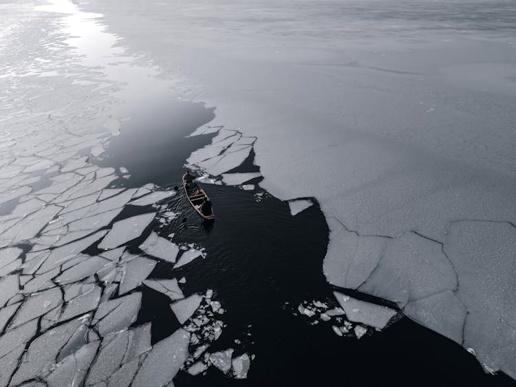 Small Boat Sailing On A Frozen Sea