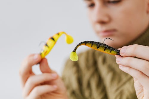 Person Holding Fishing Lures