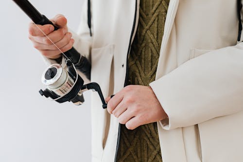 Person Holding a Fishing Rod