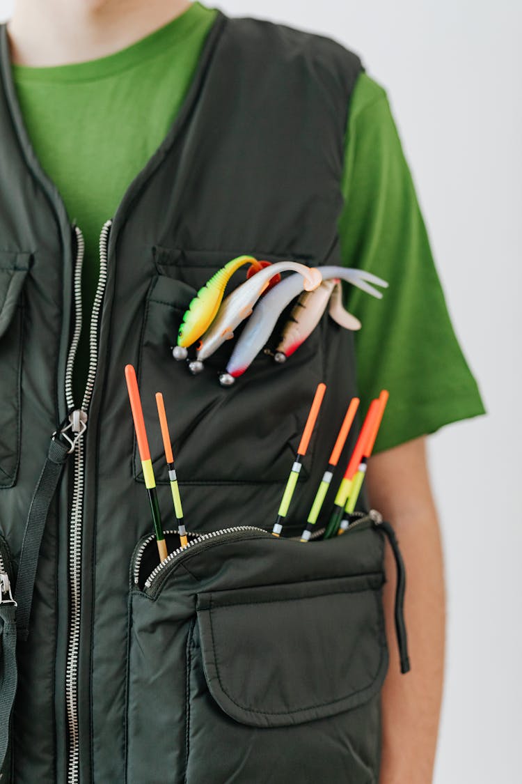 Fishing Floats And Lures On Black Vest