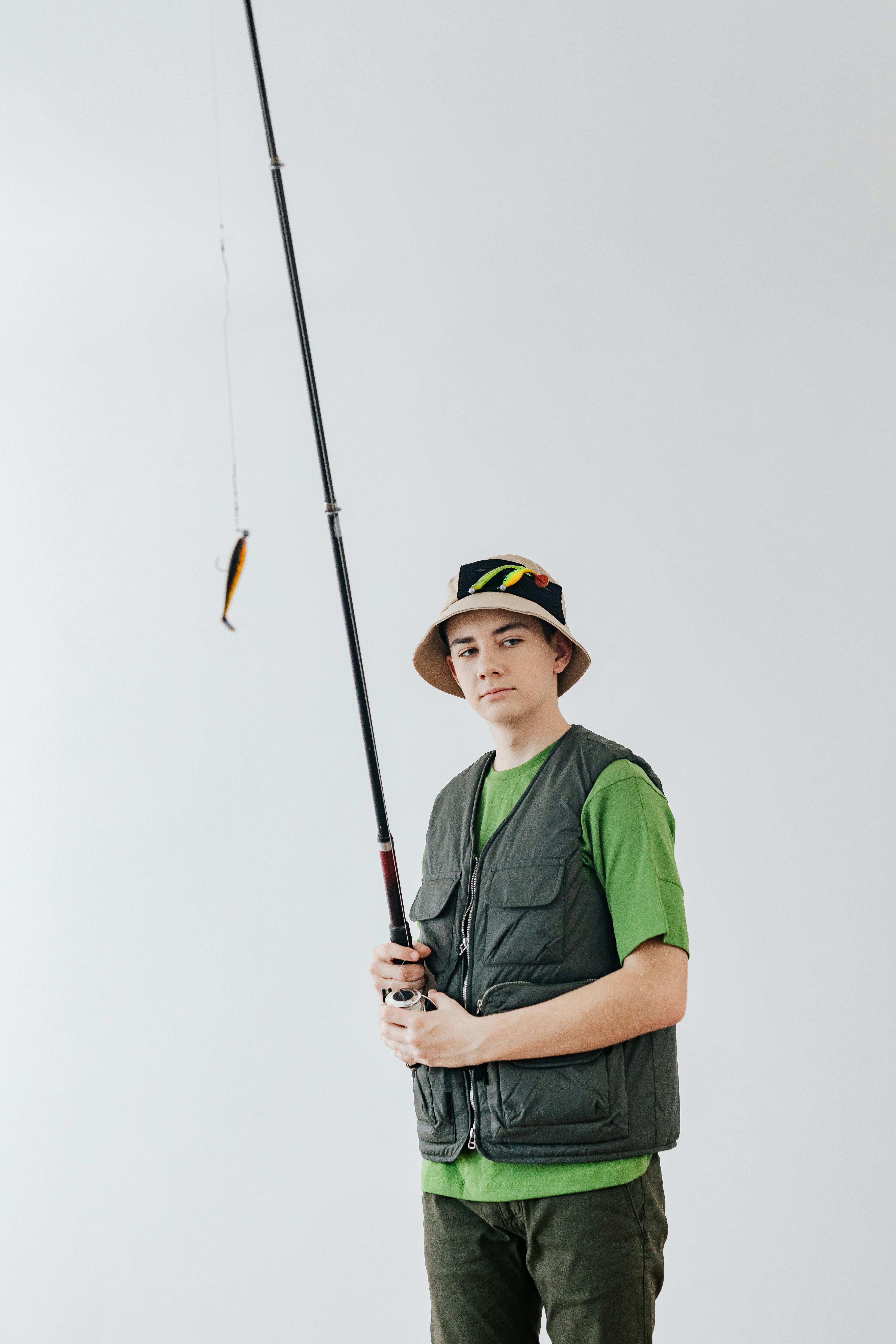 Person Holding a Fishing Rod · Free Stock Photo