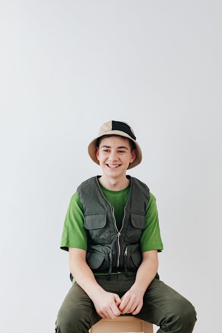 Boy Wearing A Vest And A Bucket Hat