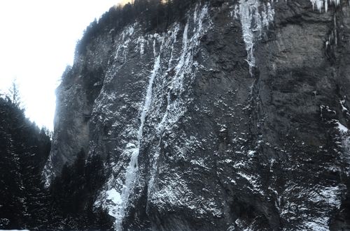 Free Breathtaking view of snow-covered cliffside in winter, showcasing Switzerland's natural beauty. Stock Photo