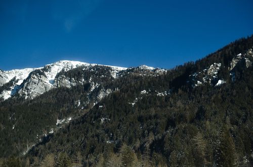 Free Scenic view of a snow-capped mountain range in Switzerland under a clear blue sky. Stock Photo