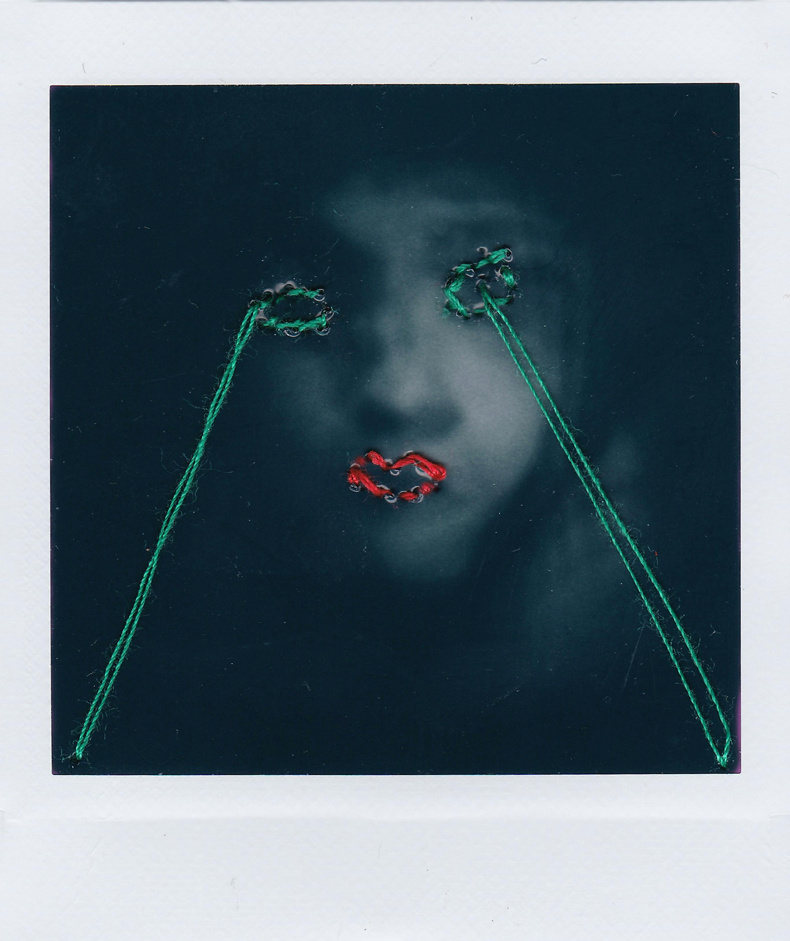 Artistic portrait with embroidered accents over facial features creating a conceptual look.