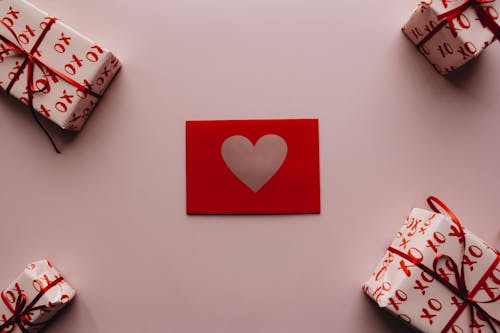 Free Four Gifts and a Card on the Table Stock Photo
