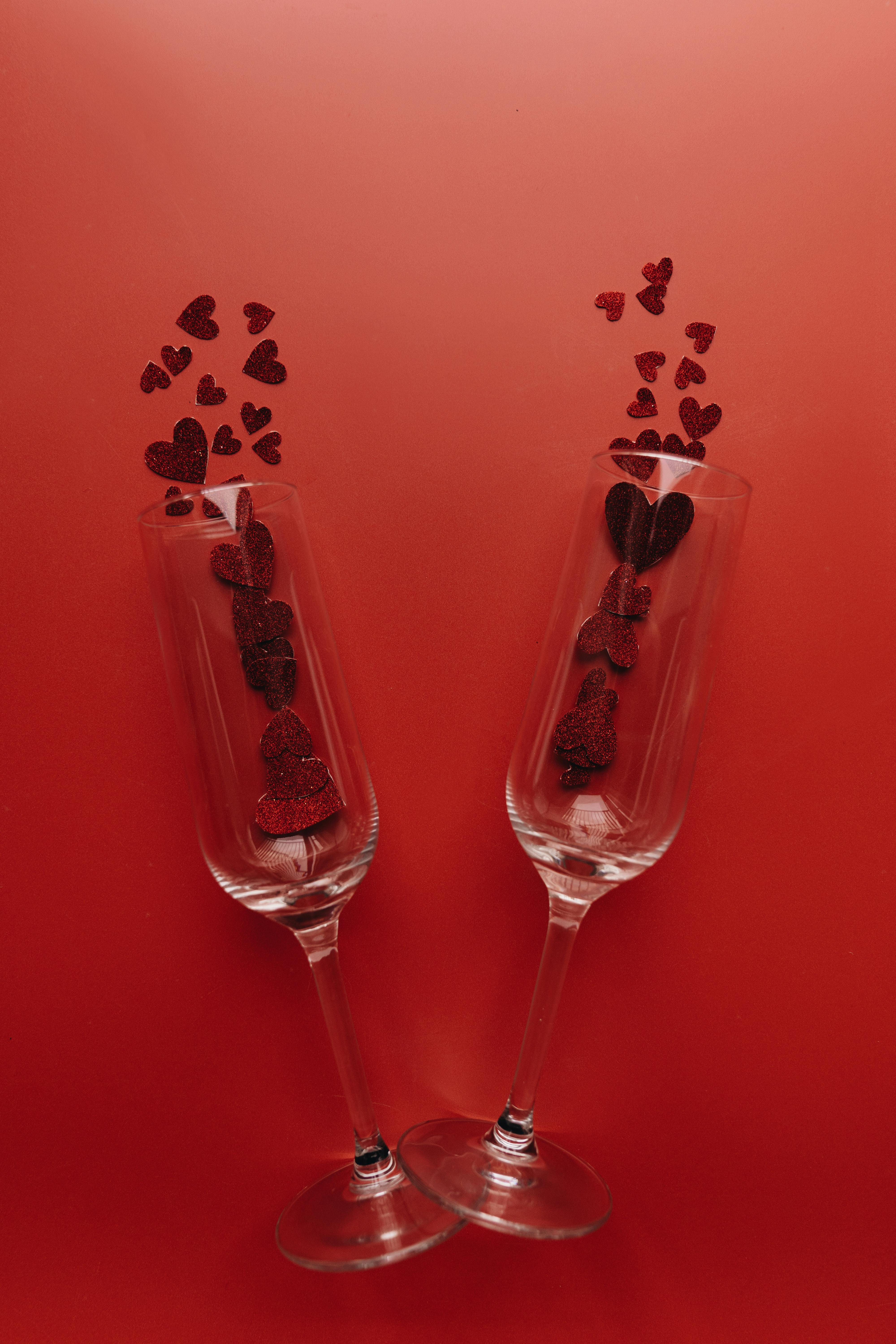 Elegant champagne glasses with heart decorations for a romantic Valentine's setting.