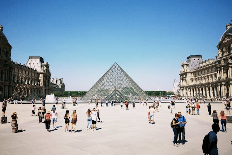 People Surrounding The Glass Pyramid