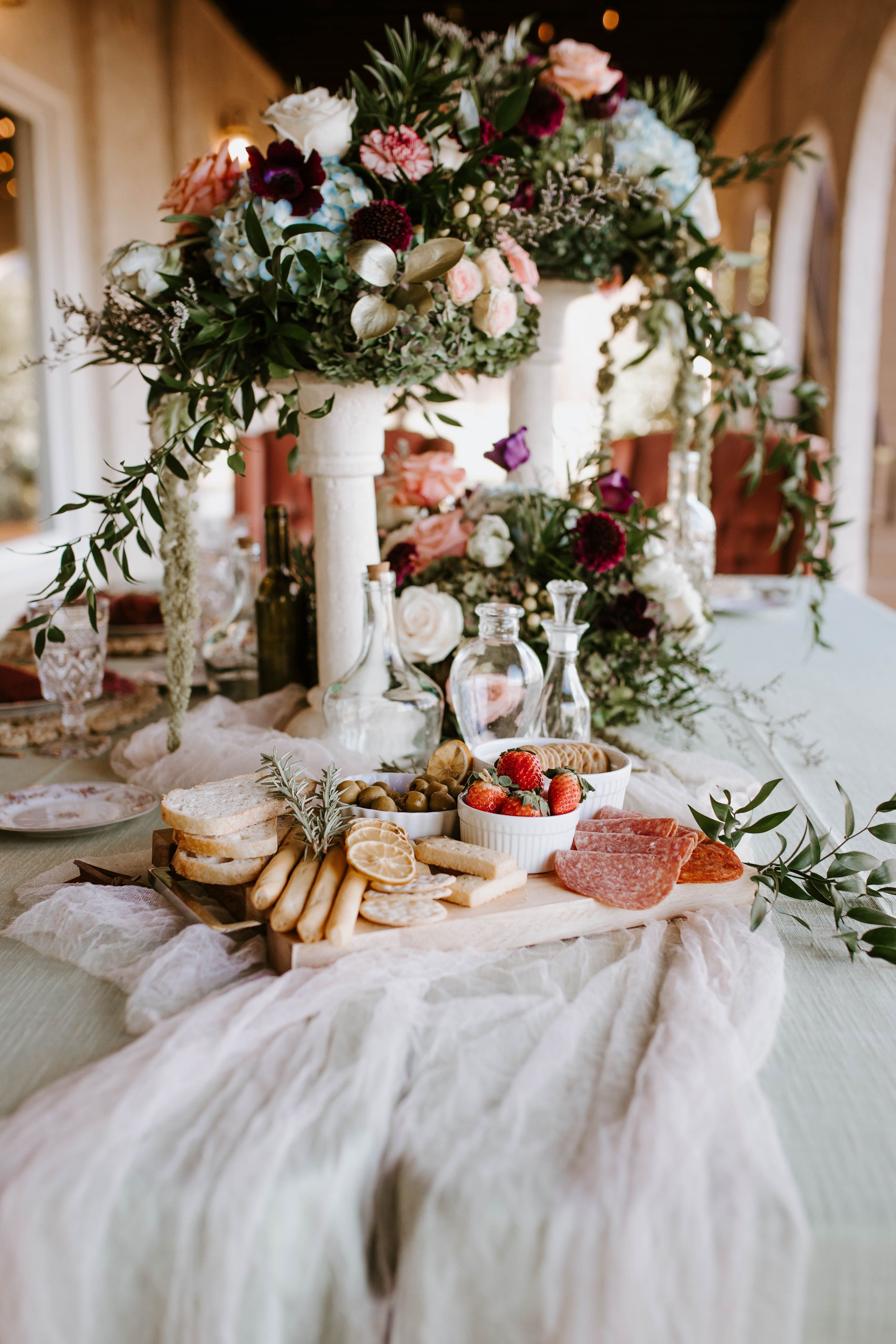 An elegant catered table with flowers and glassware