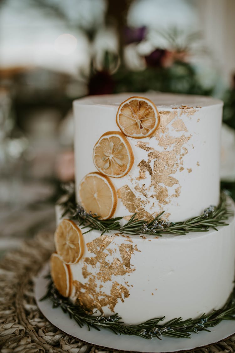 Wedding Cake Decorated With Branches Of Rosemary And Dried Orange