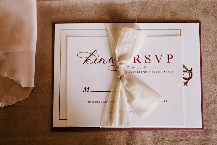 Invitation Card With The Inscription Tied With Ribbon