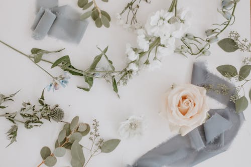 Flowers and branches with ribbon in floral workshop