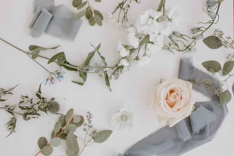 Flowers And Branches With Ribbon In Floral Workshop