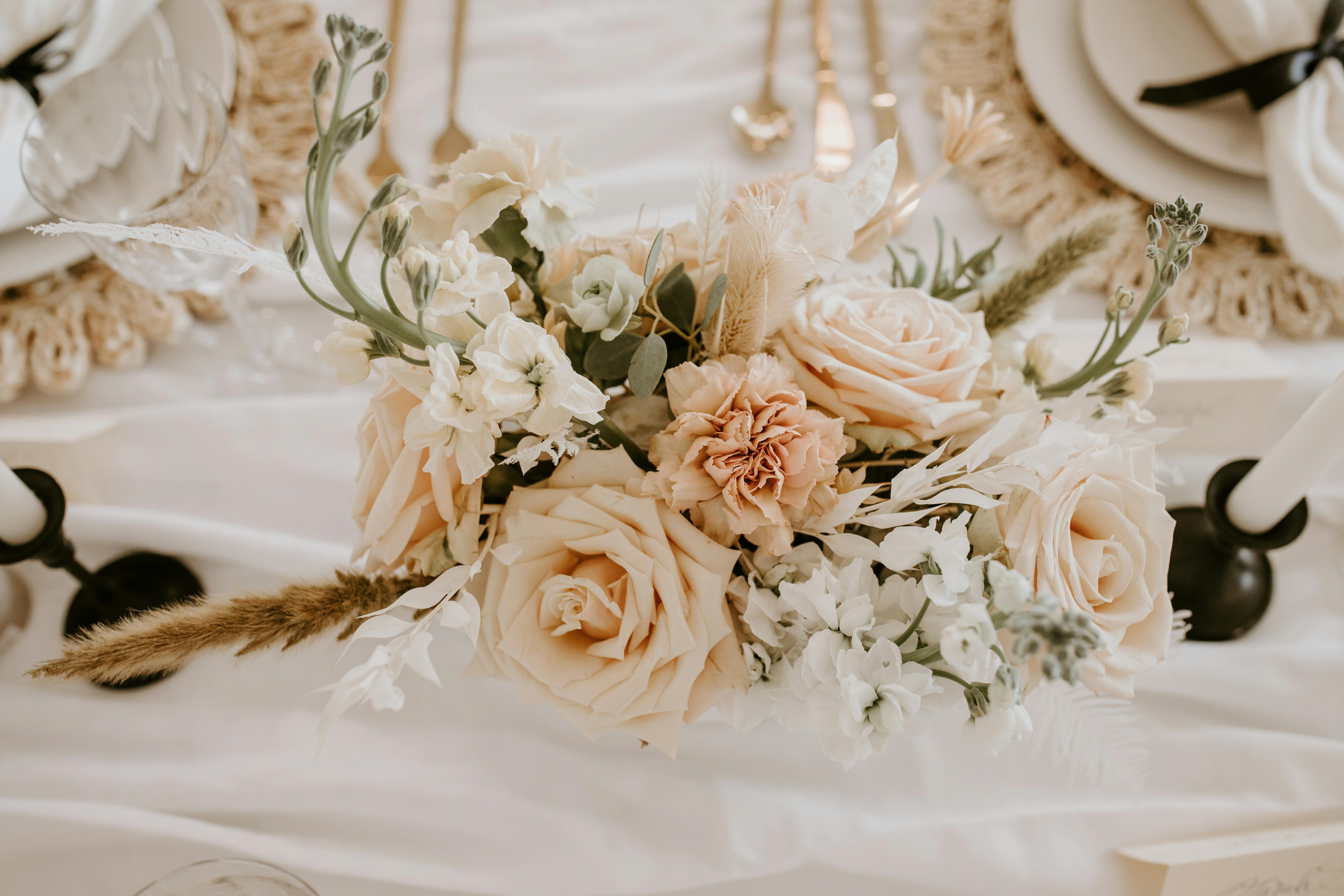 elegant flowers placed on table near candles