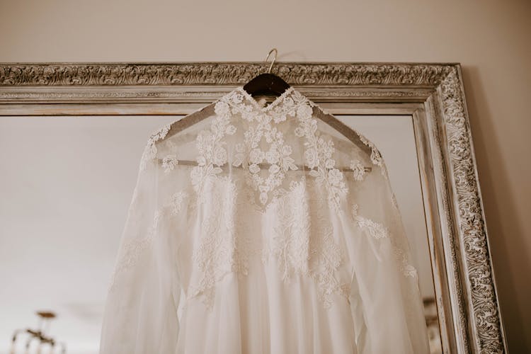 Elegant Bridal Dress Hanging On Mirror