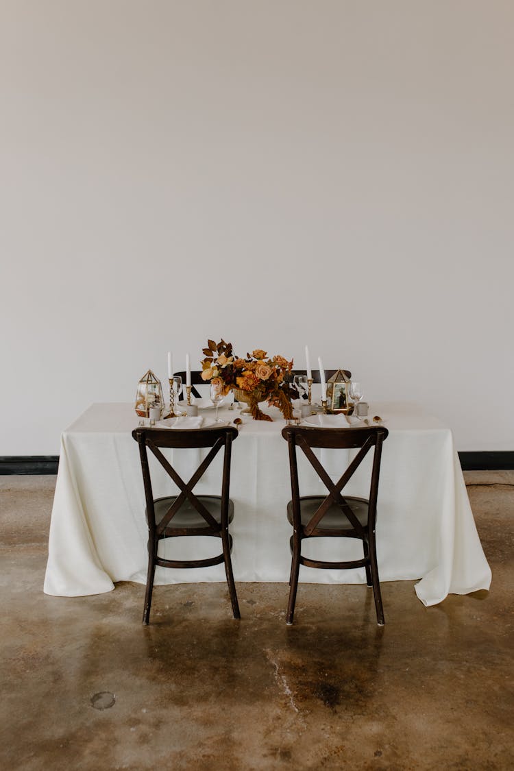 Served Table Decorated With Candles And Flowers