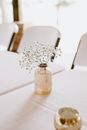 Glass vase with white blooming flower