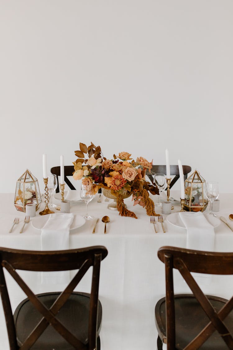 Served Table Decorated With Flowers Bouquet And Candles During Festive Dinner