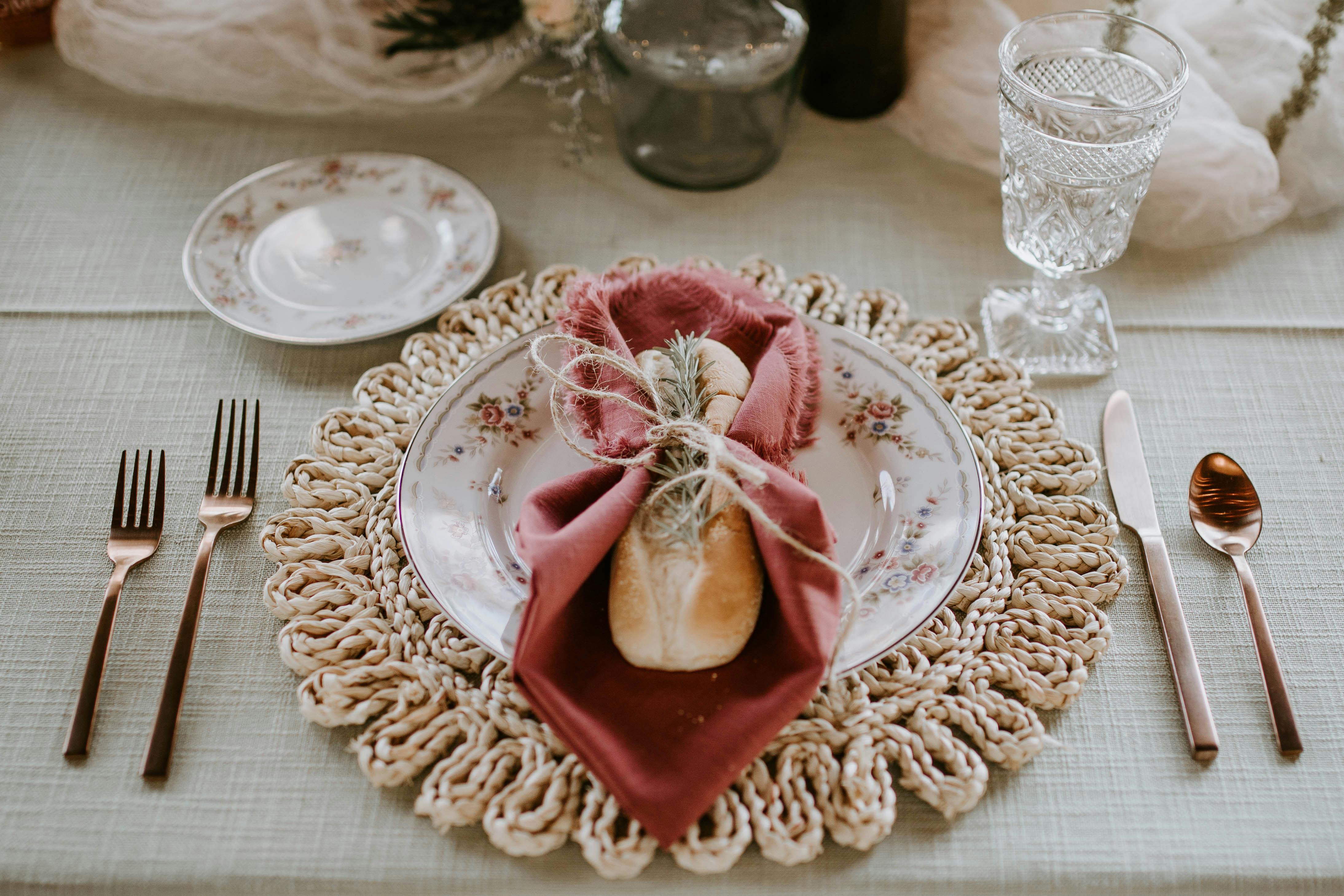 elegant plate with bread and napkin served on decorated table