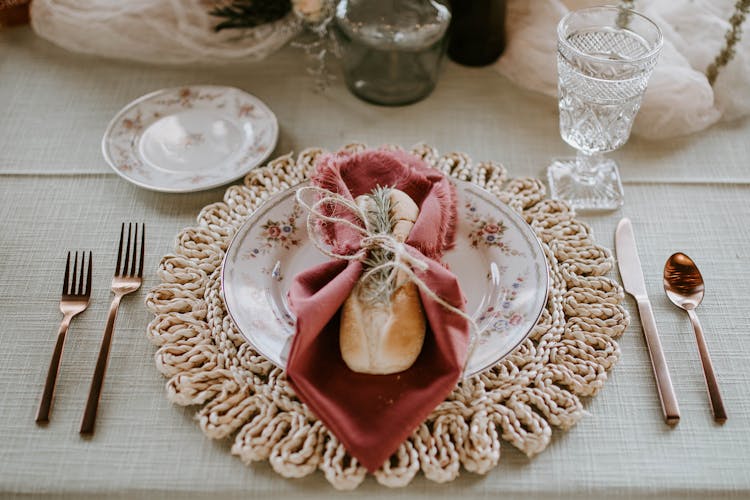 Elegant Plate With Bread And Napkin Served On Decorated Table