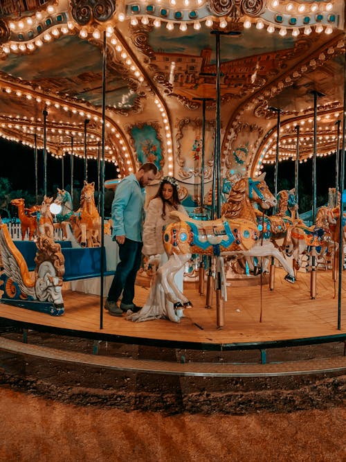 Man and Woman Riding on Carousel
