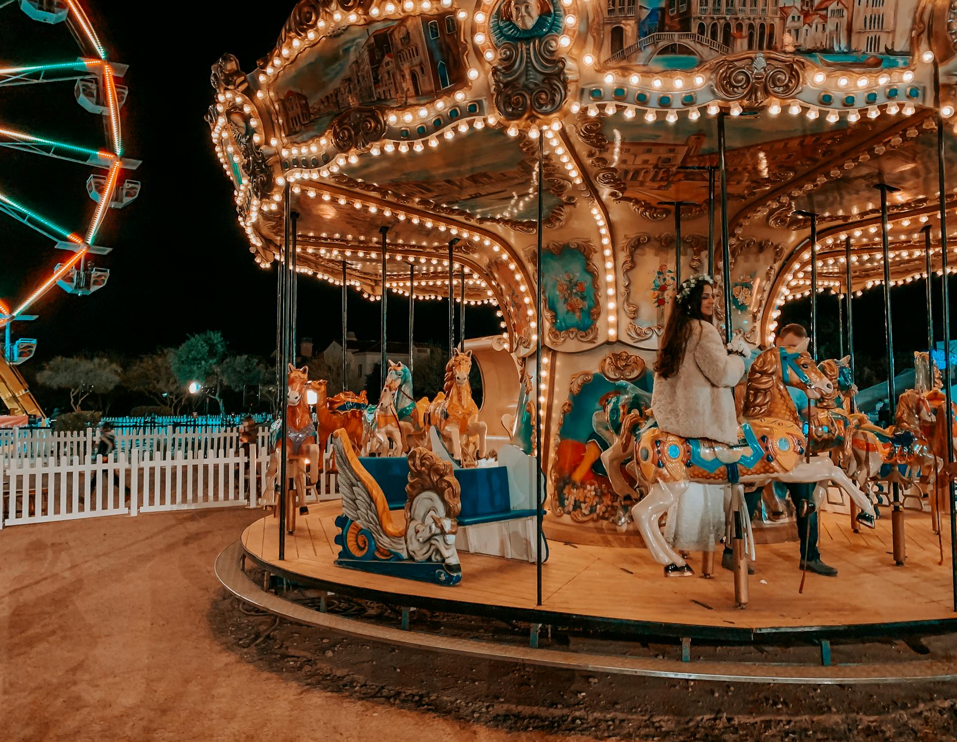 Enjoy a magical evening on the illuminated carousel ride at a Scottsdale fairground, Arizona.