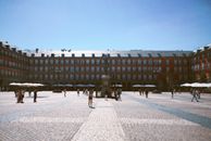 People Walking on Street Near Brown Concrete Building