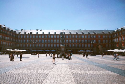 People Walking on Street Near Brown Concrete Building
