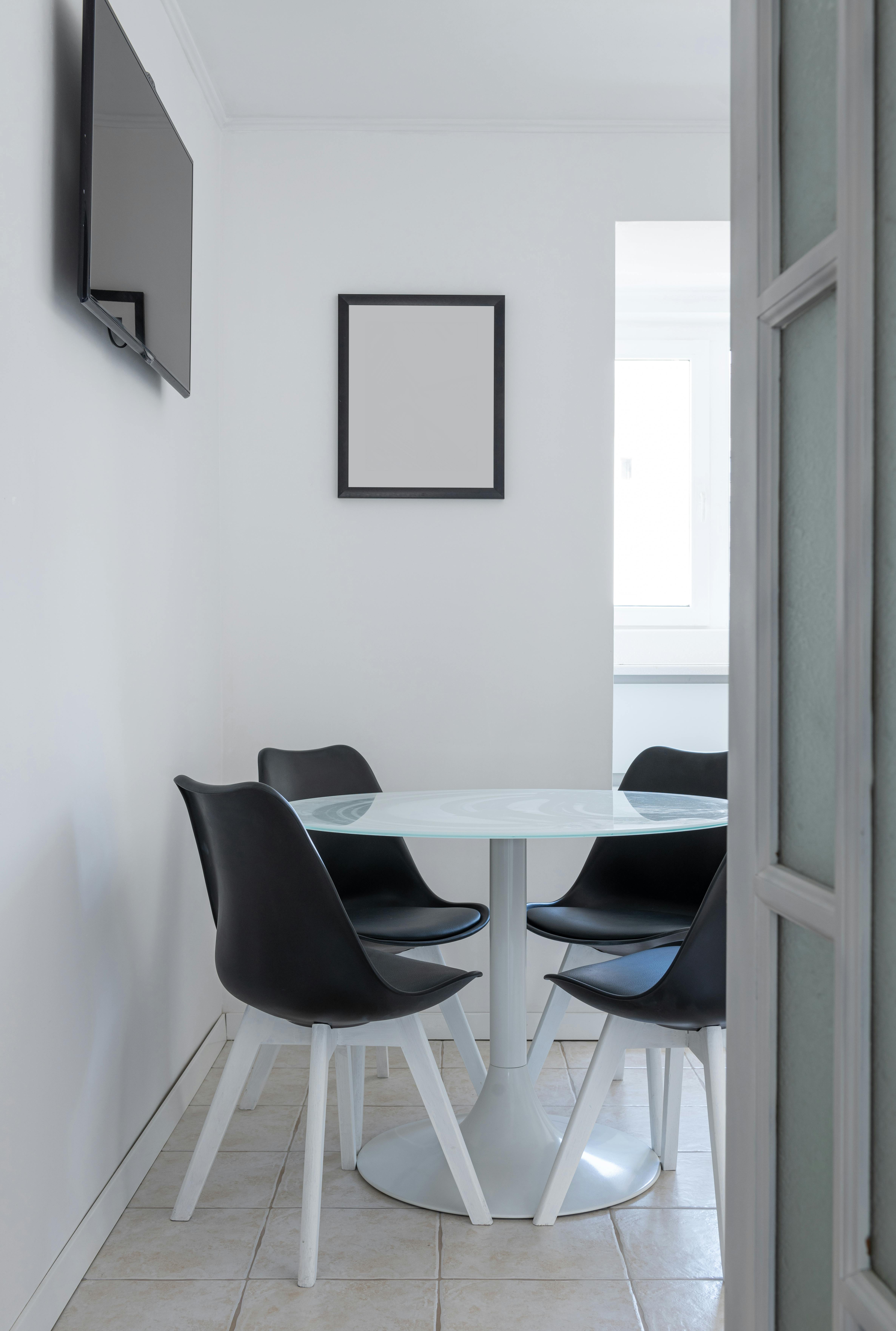 interior of light apartment with table near chairs and tv