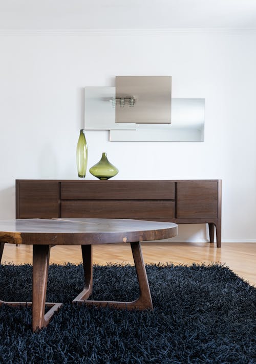 Interior of modern home with table on carpet near cabinet