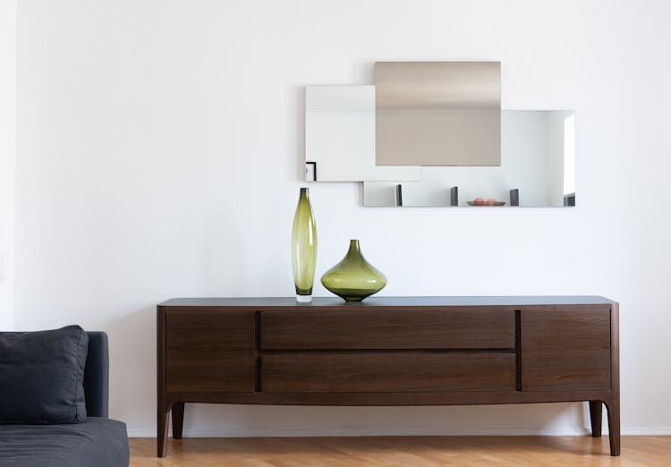 Apartment Interior With Cabinet With Vases Near Mirror