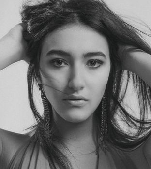 Artistic black and white portrait of a woman with earrings in Kyiv