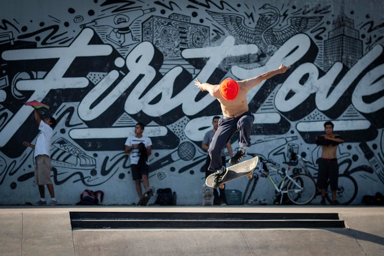 Shirtless Skater Doing A Trick