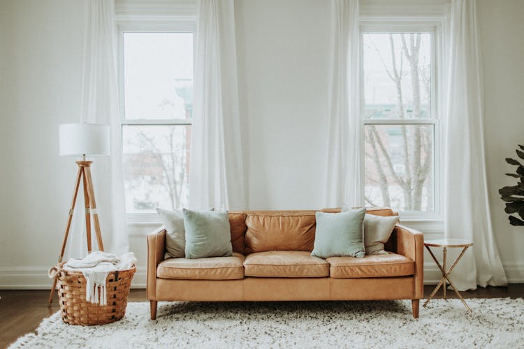 White And Brown Sofa Chair Near White Window Curtain