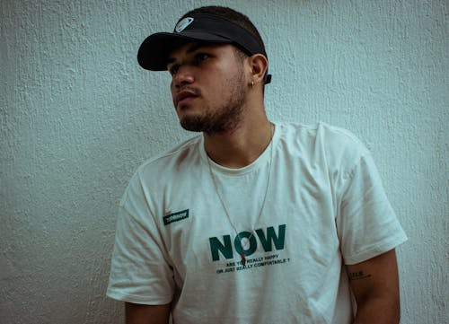 A Man in White Crew Neck T-shirt Wearing Black Visor Cap