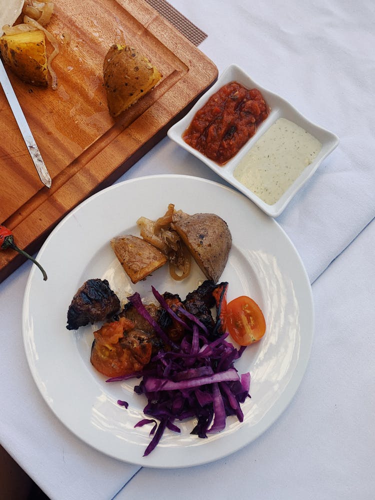 Grilled Meat And Cooked Vegetables On Plate