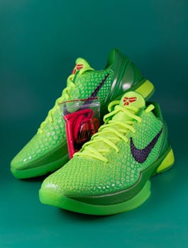 Bright green Nike sneakers with a stylish texture on a matching background. Includes extra laces.