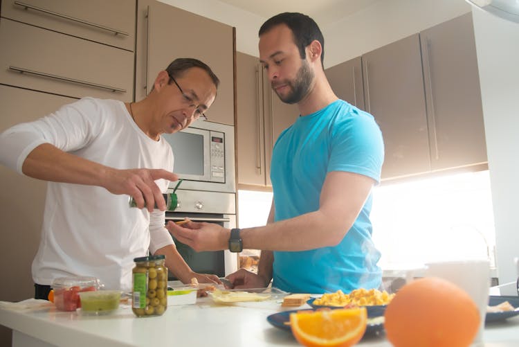 Men Preparing Breakfast Together At Home