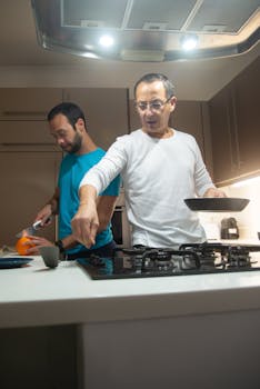 Two men cooking together in a contemporary kitchen, fostering togetherness.