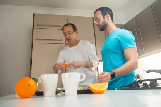 Two men preparing breakfast together in a modern kitchen, enjoying quality time.