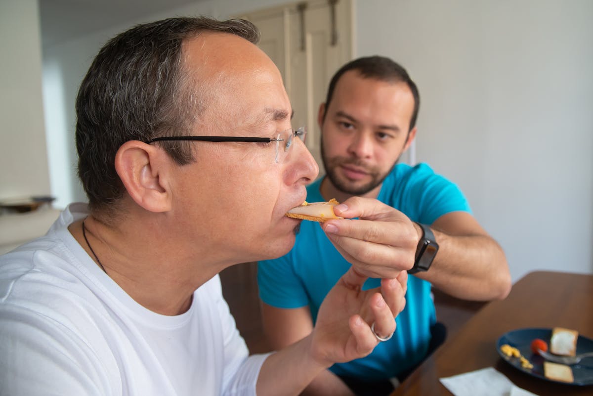 Person in an oversized cable knit sweater holding a hot drink