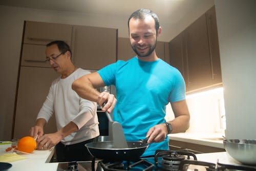 Man in Blue Crew Neck T-shirt Cooking