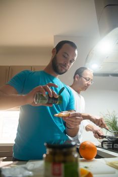 Two men cooking breakfast together in a bright, cozy kitchen setting.