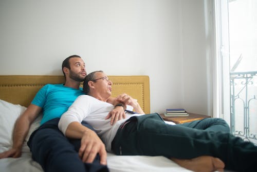 Free Romantic Couple Lying on the Bed Stock Photo