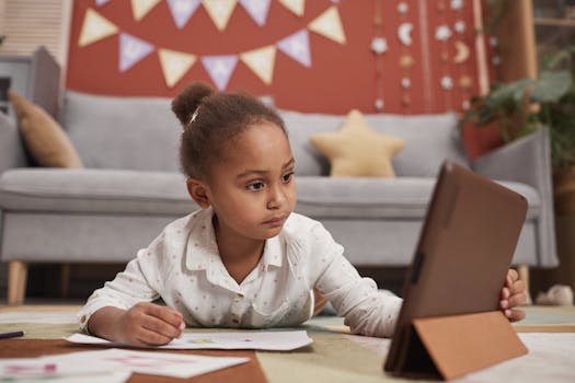 A young girl focused on learning online with a tablet in a cozy home setting.