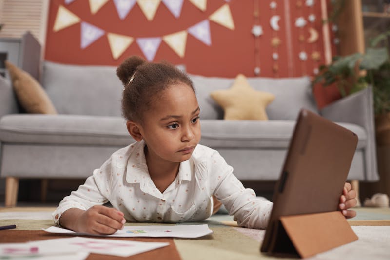Girl using digital tablet for learning
