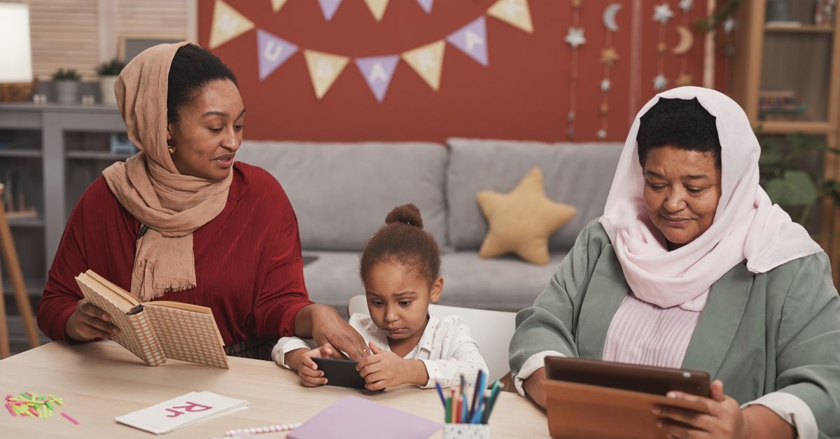 A family of three reading and learning together at home, celebrating Ramadan.