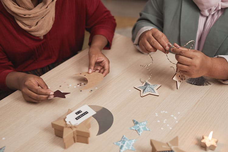 Moon And Star Cutouts On Wooden Table